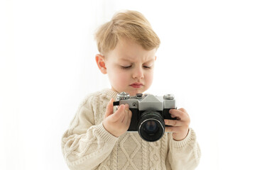 A little boy with a camera in his hands