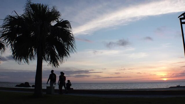 CHTAN-CHO, OKINAWA, JAPAN - AUG 2021 : View of Araha beach (Ocean or sea) in sunset time. Wide view, long time lapse shot, dusk to night. Summer holiday, vacation and resort concept shot.