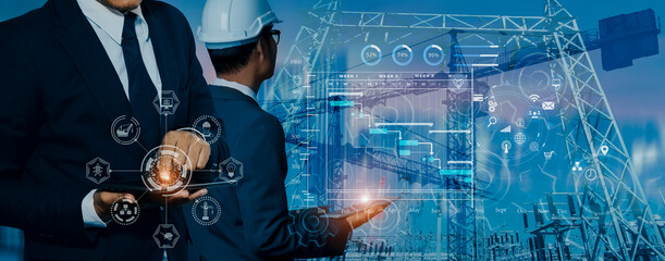 Future building construction engineering and technology project concept. double exposure graphic with engineer using digital tablet and smart industry and IOT software to control operation.