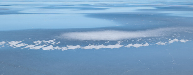 Fototapeta na wymiar Abstract background of ice structure in a frozen lake landscape. Farnebofjarden national park in northof Sweden.