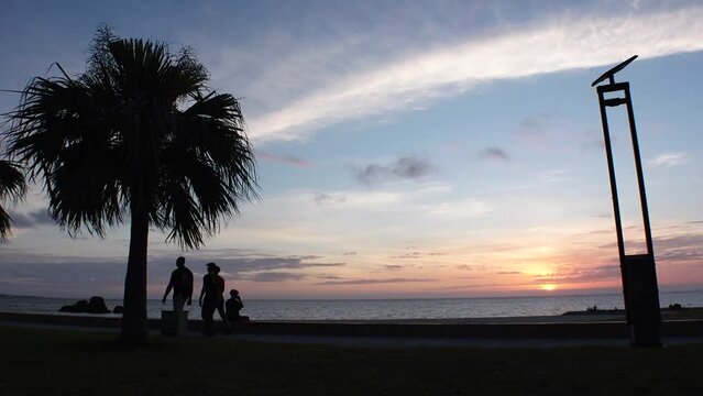 CHTAN-CHO, OKINAWA, JAPAN - AUG 2021 : View of Araha beach (Ocean or sea) in sunset time. Wide view, long time lapse shot, dusk to night. Summer holiday, vacation and resort concept shot.