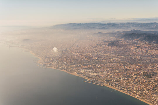 Sea by city landscape in foggy weather