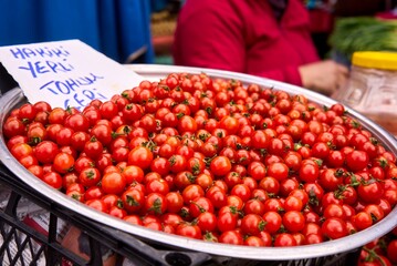Closeup of red ripe cherry tomatoes at farmers market place. High quality photo