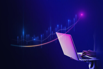 Close up of hand holding laptop with glowing business chart on dark blue background. Stock, market...