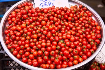 Closeup of red ripe cherry tomatoes at farmers market place. High quality photo