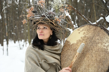 Portrait of a shaman woman in a winter forest