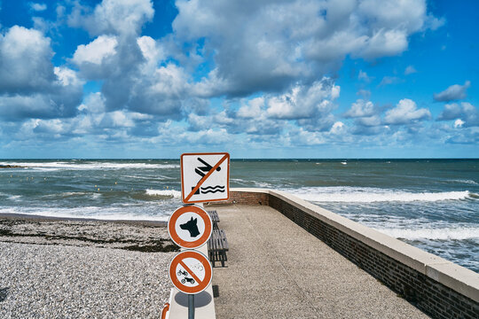 Forbidden sign boards on jetty by sea