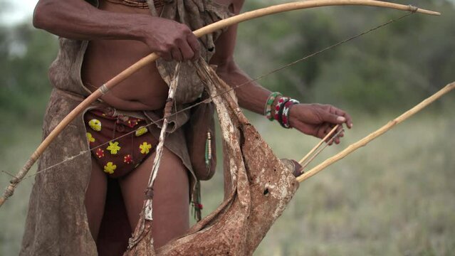 A native man placing an arrow into his bow