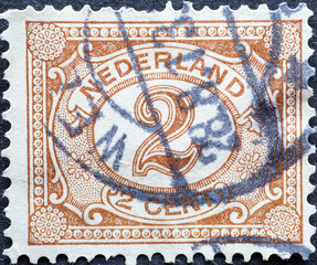 Netherlands - circa 1899 a postage stamp from the Netherlands , showing an ornament with number