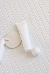Skincare beauty cosmetic concept. White tube of cream lotion cleanser antioxidant facial oil on white background in a bathroom, vertical