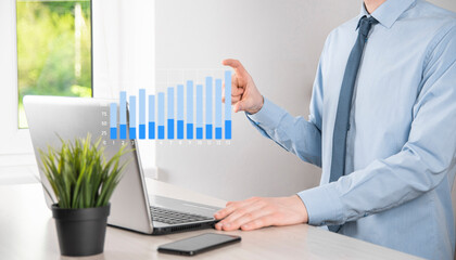 Business man holding tablet and showing holographic graphs and stock market statistics gain profits. Concept of growth planning and business strategy. Display of good economy form digital screen.