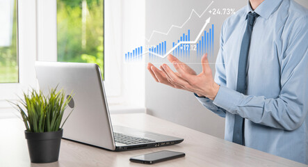 Business man holding tablet and showing holographic graphs and stock market statistics gain profits. Concept of growth planning and business strategy. Display of good economy form digital screen.