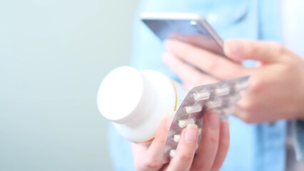unrecognizable woman reading online medication instructions. Doctor and online consultation. Contraindications and prescription pills.