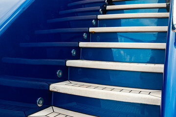 Upward-facing teak stairs on a luxury yacht.