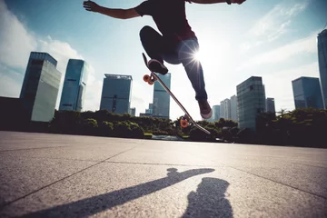 Gordijnen Skateboarder skateboarding outdoors in city © lzf