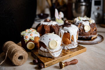 cooking Easter cakes. Eastern europe Russian and ukrainian Easter cake kulich decorated with sweet sugar icing. traditional Easter cake with glaze in kitchen, closeup