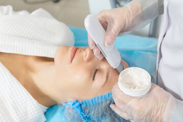 Ultrasonic facial cleansing performed by a professional cosmetologist in a beauty salon. Gently exfoliates the upper layer of the skin, promotes better penetration of nutrients and medicinal products