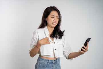 woman feel disgusted and shocked while looking at her mobile phone