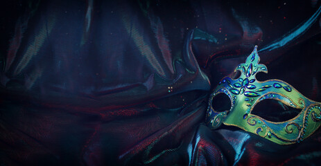 Naklejka premium Photo of elegant and delicate Venetian mask over dark background. banner