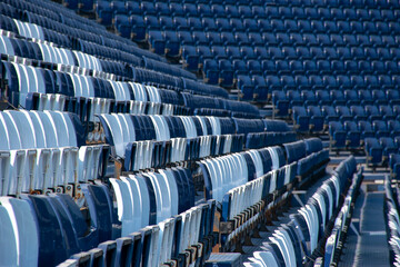Blue and white seats on the bleachers in the football stadium
