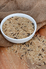 mixture of wild rice and brown rice on a rustic table surface