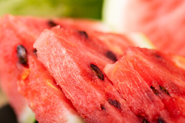 Heap of fresh sliced watermelon as textured background. Sweet and juicy sliced watermelon