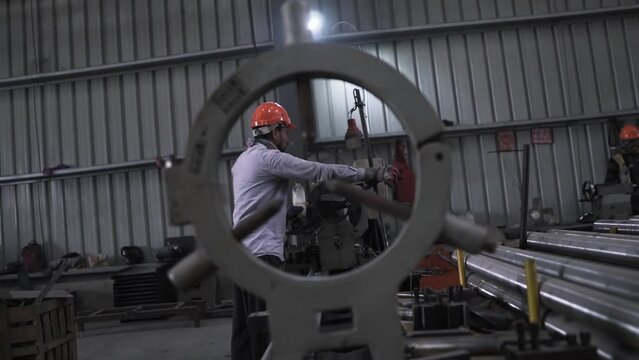 slow motion portrait of Indian working class manpower at work in a metallurgic manufactory factory line production iron and heavy metal fusion