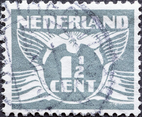 Netherlands - circa 1934: a postage stamp from the Netherlands, showing a stylized graphic. Flying...