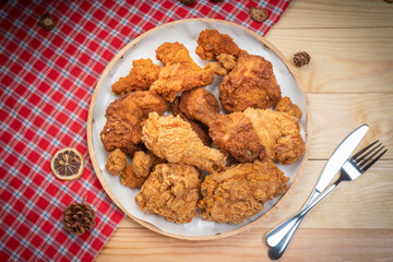 Fried chicken in wooden plate on wooden background, Deep fried Chicken on wooden table.