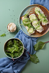 Healthy breakfast, natural food concept. Sandwiches with potion on a green background