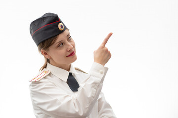 Beautiful young female Russian police officer in dress uniform shows signs with her hands on a white background. Selective focus. Portrait