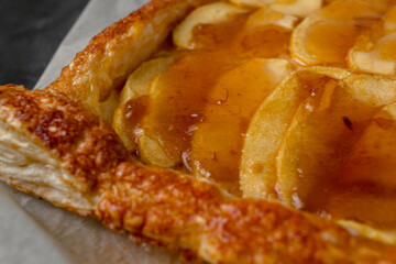Close up of homemade apple pie with marmalade in dark mood photo style.