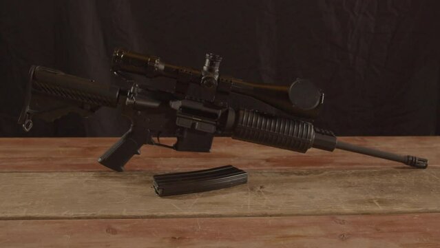Dolly in of unloaded AR-15 rifle with a magazine in the foreground