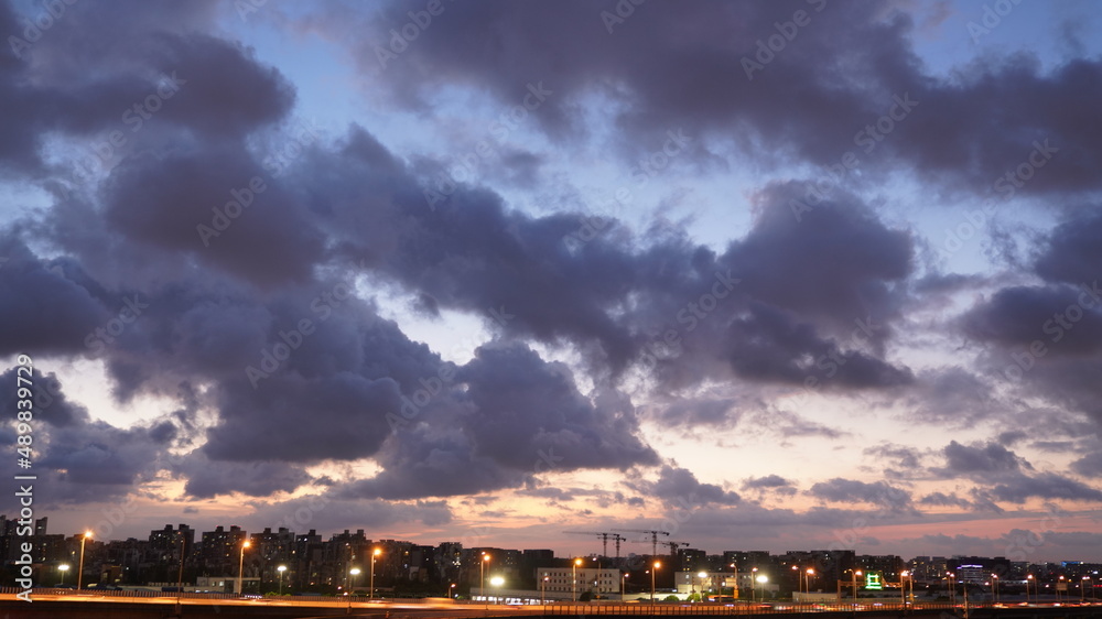Wall mural the beautiful sunset view with the colorful clouds and sky in the city