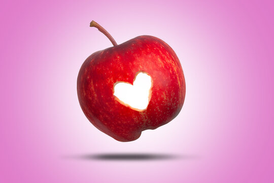 Red apple love heart on pink background
