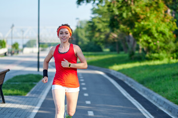 Running Woman on racetrack during training session. Female runner practicing on athletics race track