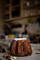 Traditional Ukraine Easter cake with icing and hand painting eggs.Homemade muffins with powdered sugar. Rustic style.