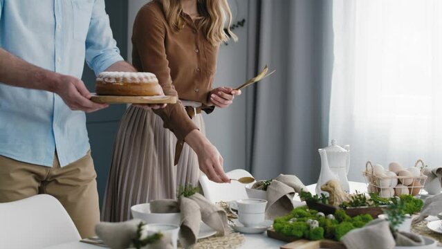 Caucasian couple preparing  table for easter dinner. Shot with RED helium camera in 8K.