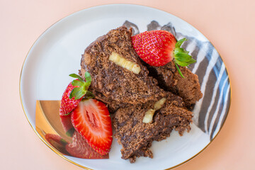Delicious and sweet chocolate cake with fresh strawberries.