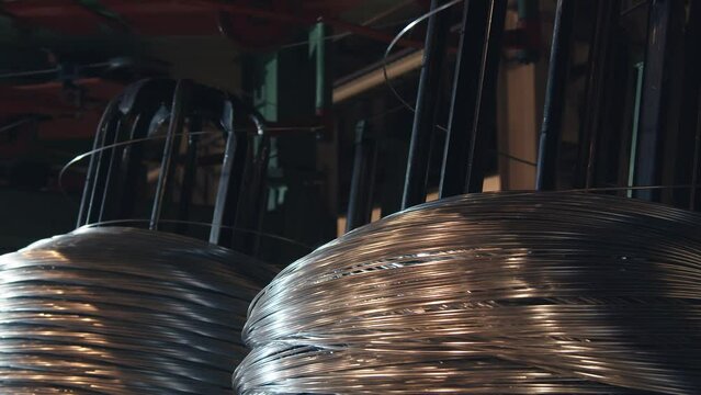 The factory produces copper wire. It is wound on special mechanisms in large rolls. it glows red