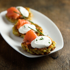 Homemade potato pancakes or lakes with salmon