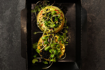  Healthy food delivery concept. Round omelette with vegetables. Restaurant dish delivery in eco paper boxes on black background. Top view. Free space for text. 