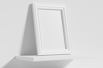 Rectangular photo frame on white shelf leaning at wall diagonal view