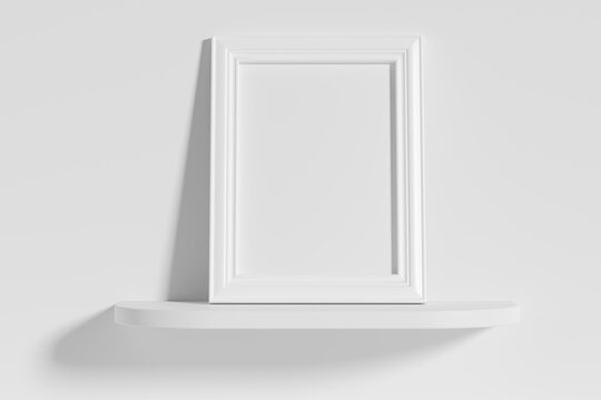 Rectangular photo frame on white rounded shelf leaning at wall