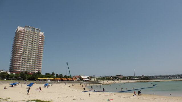 CHATAN-CHO, OKINAWA, JAPAN - AUGUST 2021 : View of Chatan sunset beach (Ocean or sea). Wide view, time lapse shot in daytime. Summer holiday, vacation and resort concept video.