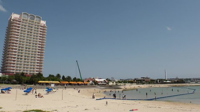 CHATAN-CHO, OKINAWA, JAPAN - AUGUST 2021 : View of Chatan sunset beach (Ocean or sea). Wide view, time lapse shot in daytime. Summer holiday, vacation and resort concept video.