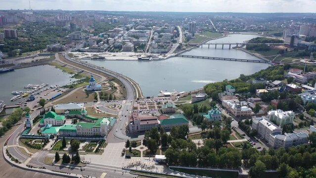 Scenic view from drone on sunny summer day of Cheboksary cityscape on banks of Volga river overlooking Holy Trinity Monastery and Assumption Church, Chuvashia, Russia. High quality 4k footage