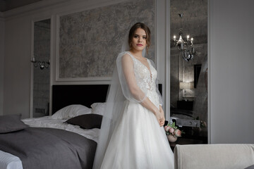 Fototapeta premium A girl in a wedding dress, a bride with flowers, delicate details.