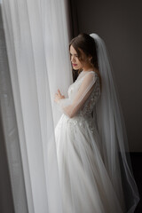 Fototapeta premium A girl in a wedding dress, a bride with flowers, delicate details.
