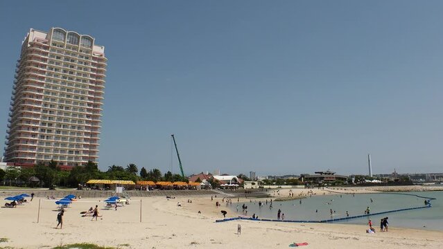CHATAN-CHO, OKINAWA, JAPAN - AUGUST 2021 : View of Chatan sunset beach (Ocean or sea). Wide view, time lapse shot in daytime. Summer holiday, vacation and resort concept video.